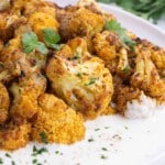 Cauliflower is seasoned with curry spices and roasted in the oven.