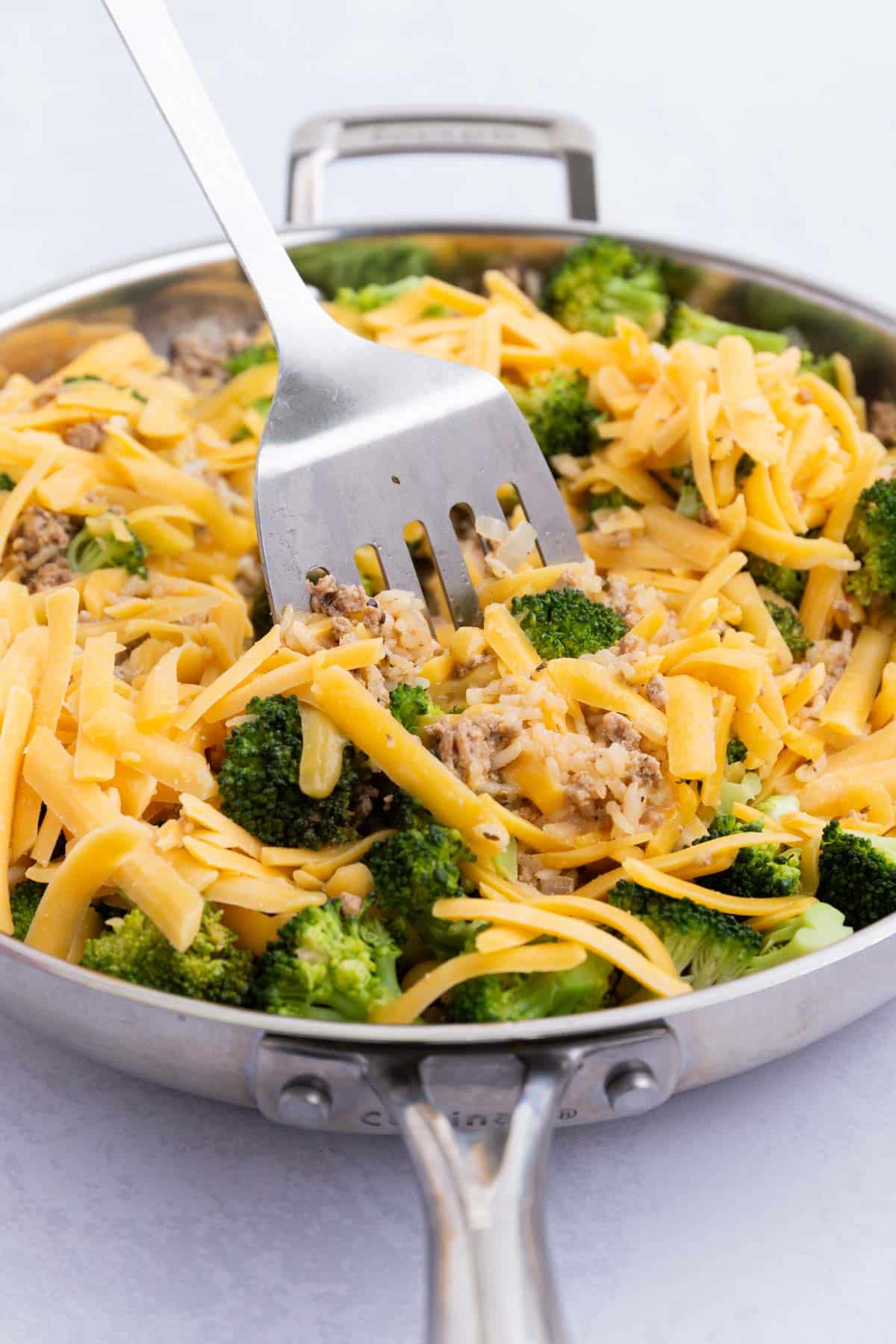Cheddar cheese is stirred into the broccoli-rice mixture.
