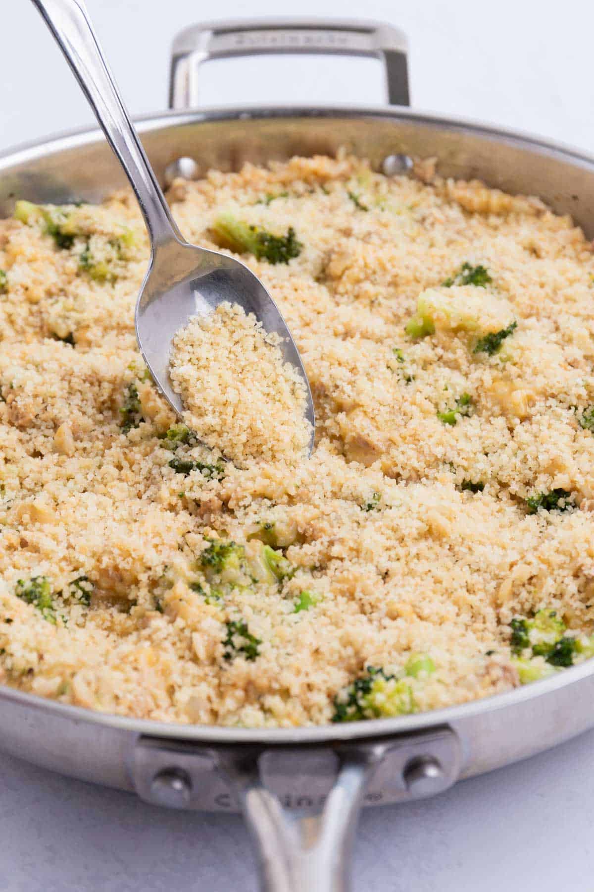 The Parmesan-bread crumb topping is spread over the cheesy mixture.