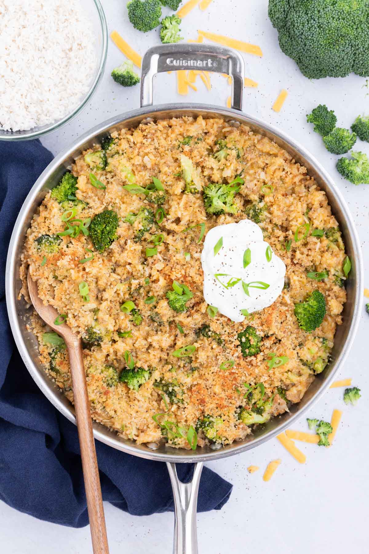 The cheesy broccoli, rice, and turkey skillet is served with a dollop of sour cream.