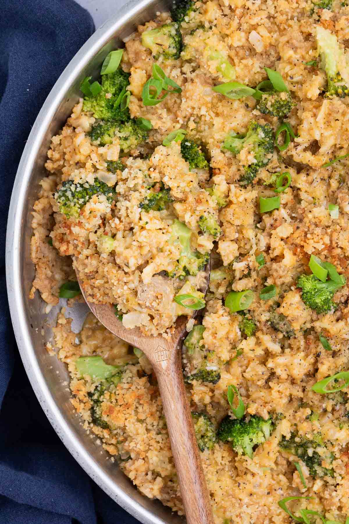 Ground Turkey Broccoli Cheese Rice Skillet RECIPE inside the skillet with a wooden spoon.