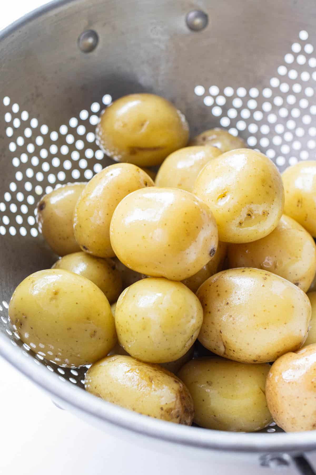 A colander full of boiled waxy potatoes.