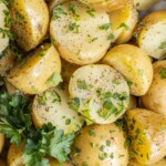 Yukon gold potatoes that are cut in half and have been boiled.