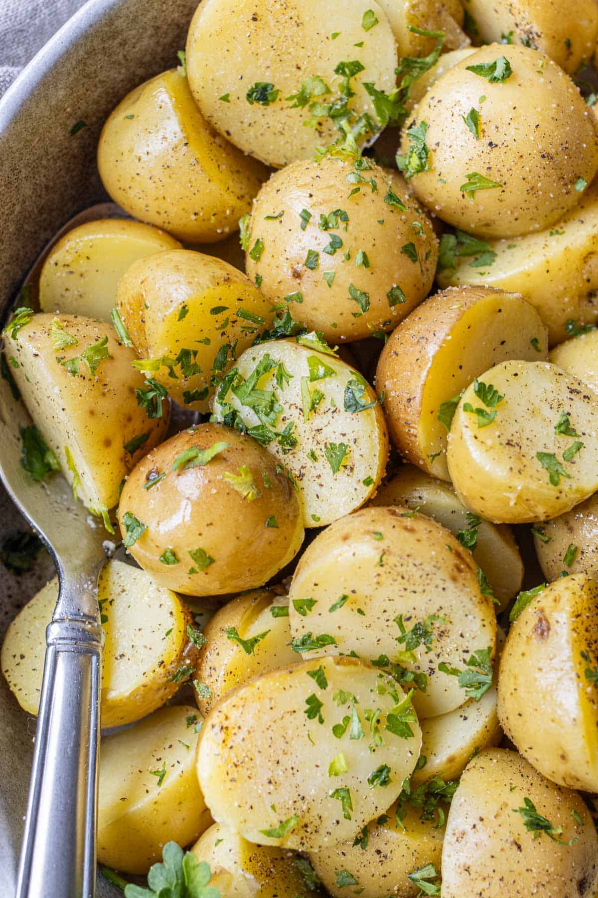 A spoon in a bowl with perfectly boiled potatoes