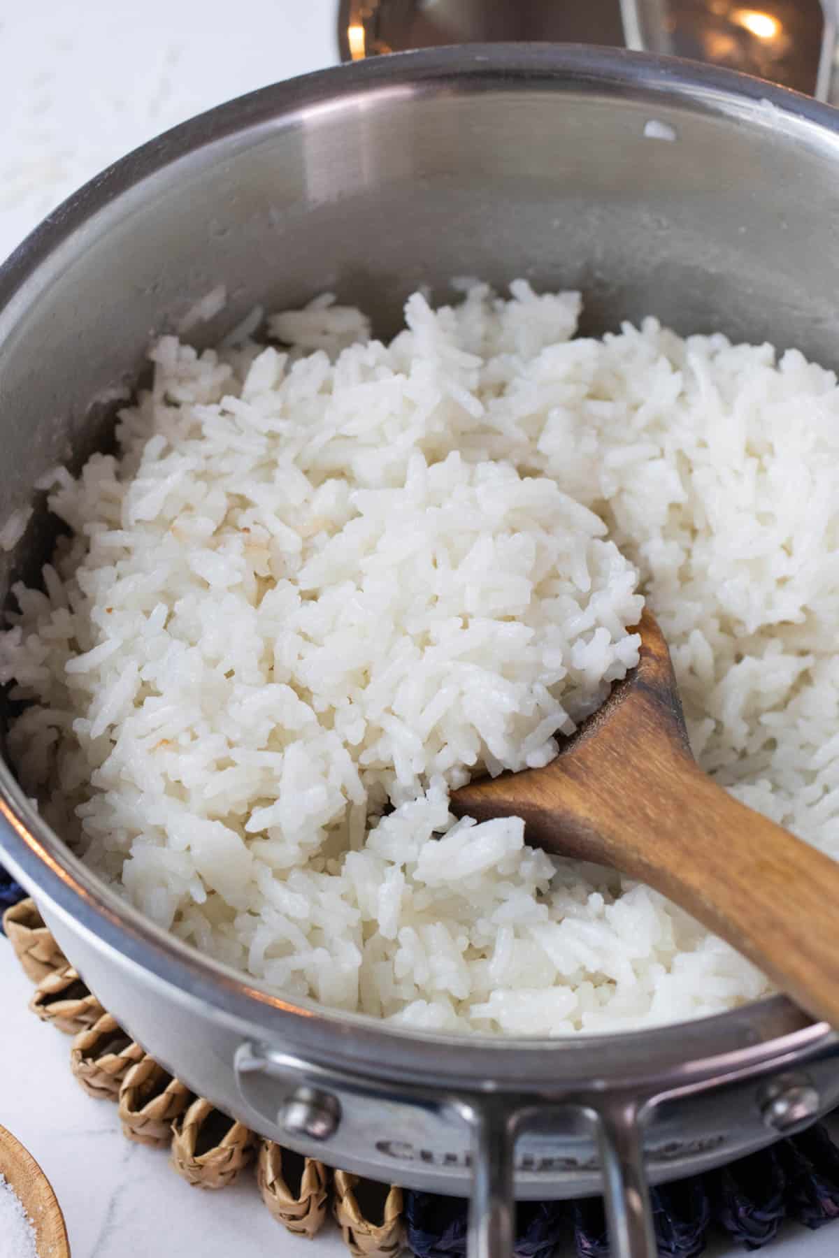 A wooden spoon serves up coconut milk rice.