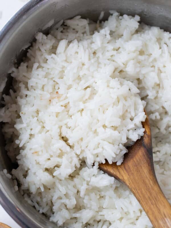 A wooden spoon serves up coconut milk rice.