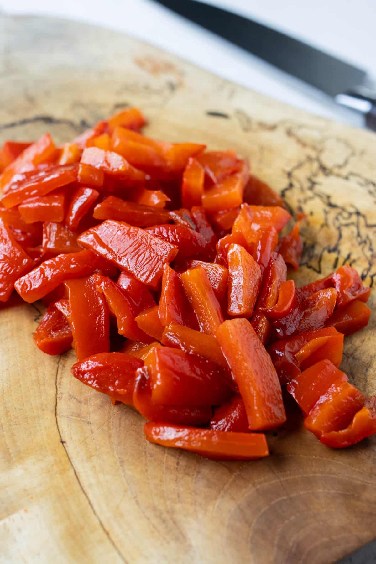 Cooked bell pepper is prepared to be chopped.