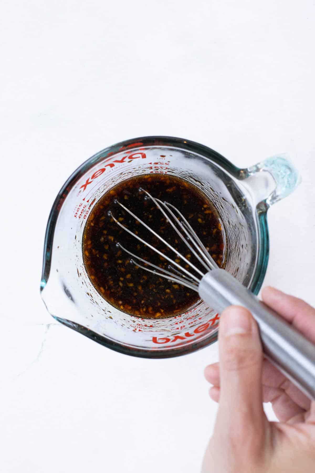 The teriyaki sauce ingredients are whisked together.