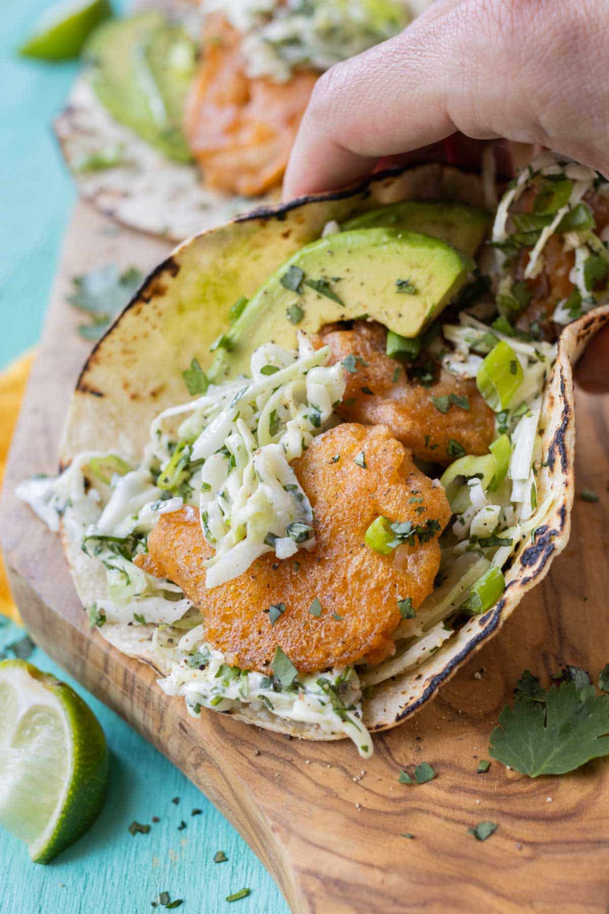 Avocado is served alongside Baja shrimp tacos.