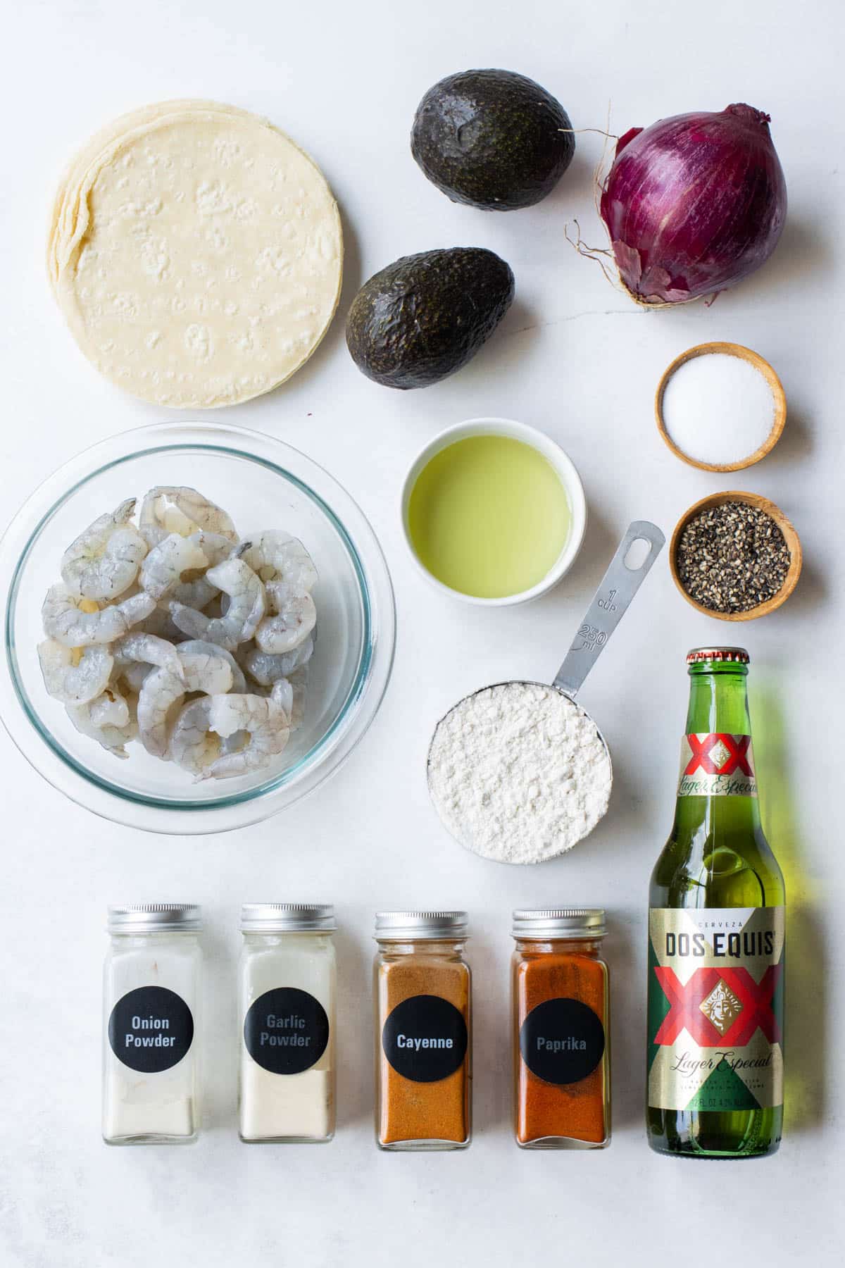 Shrimp, tortillas, fresh veggies, flour, beer, and seasonings are the main ingredients for Baja Shrimp Tacos.