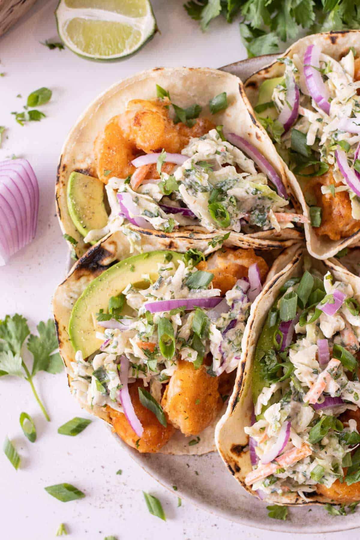 A plate full of Baja shrimp tacos are ready to serve.