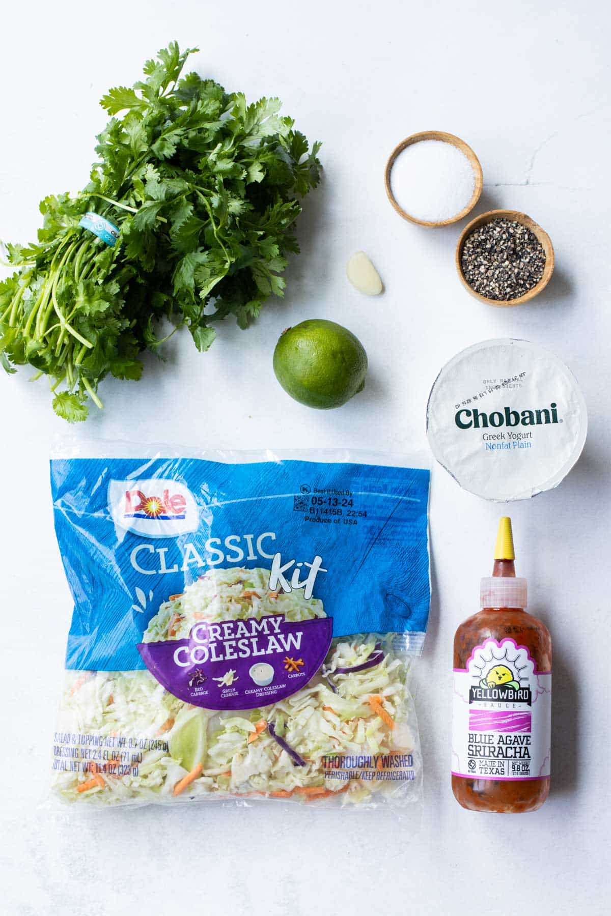 Coleslaw mix, cilantro, Greek yogurt, lime, and seasonings are the main ingredients for the cilantro slaw.