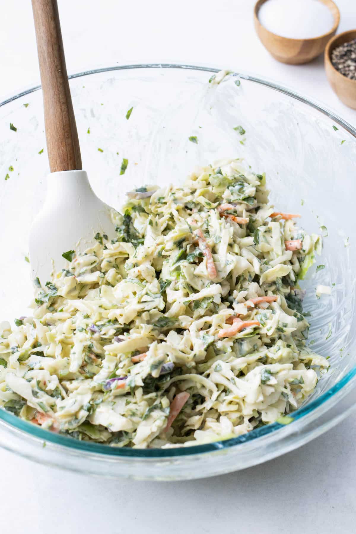 The cilantro coleslaw mix is stirred together.
