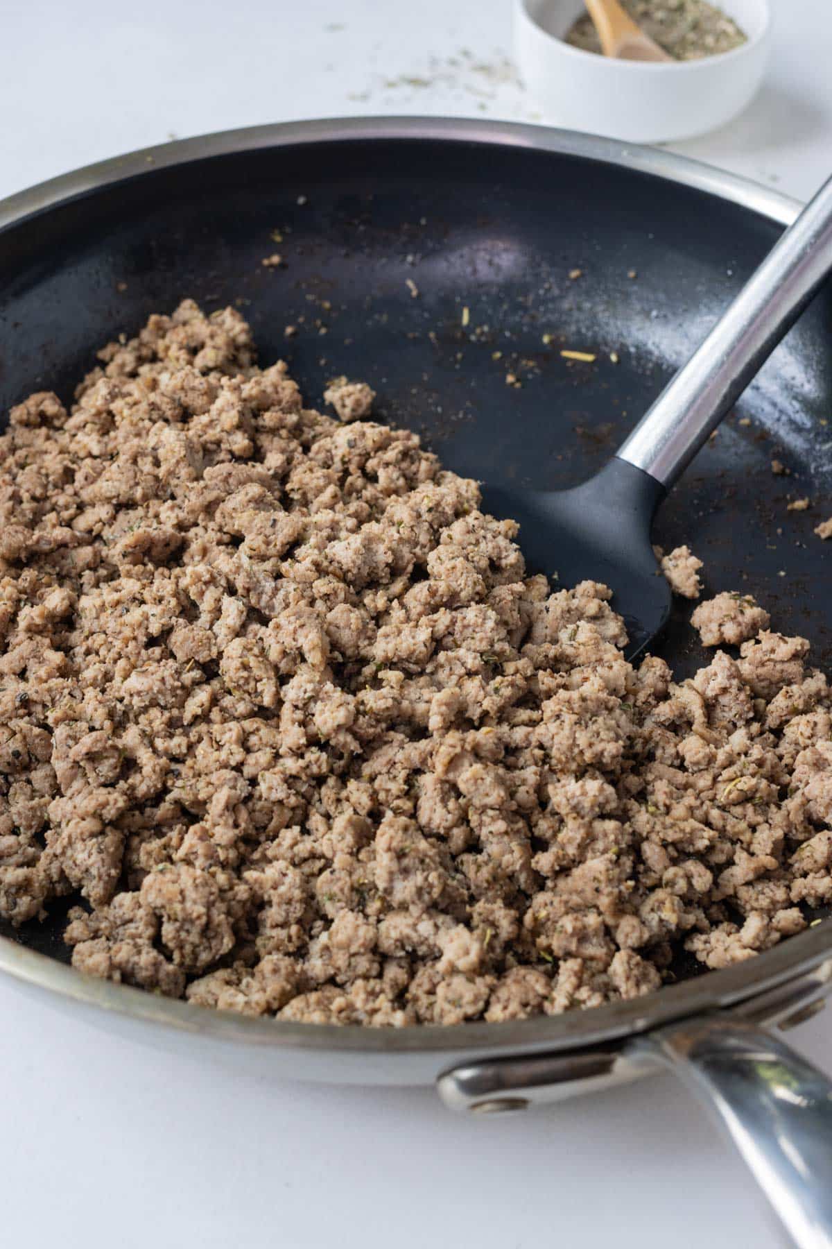 Ground turkey is cooked in a skillet.