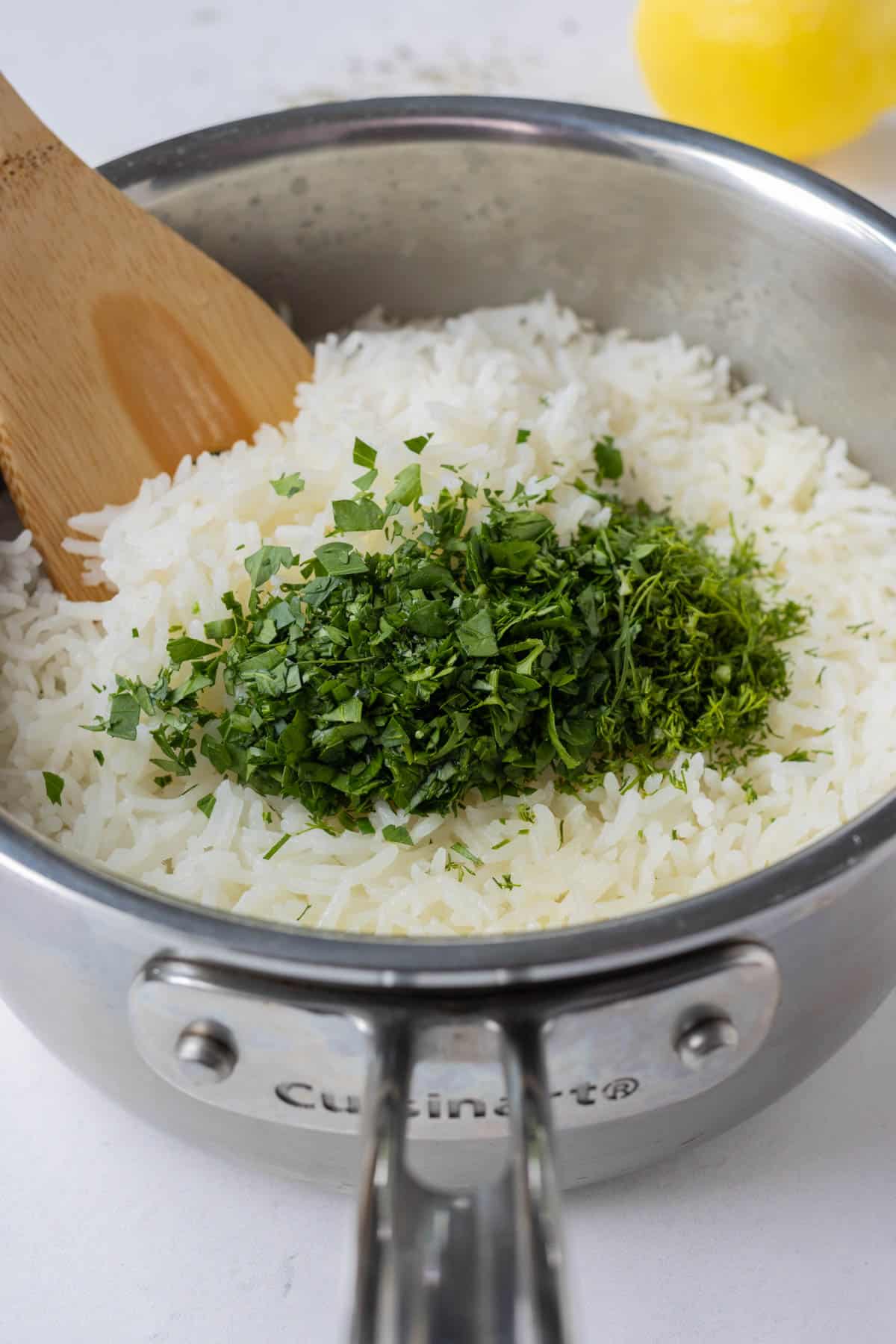 Rice is cooked and seasoned in a pot.