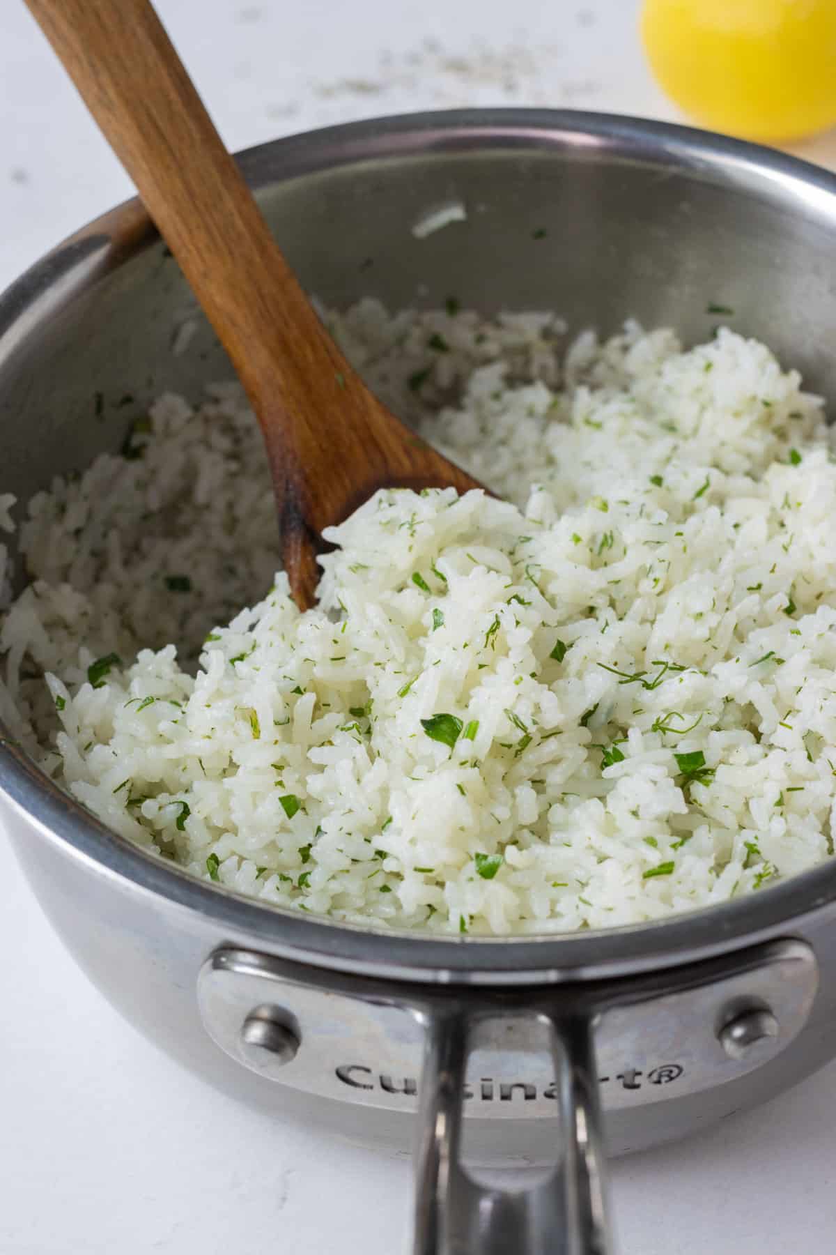 Rice is cooked and seasoned in a pot.