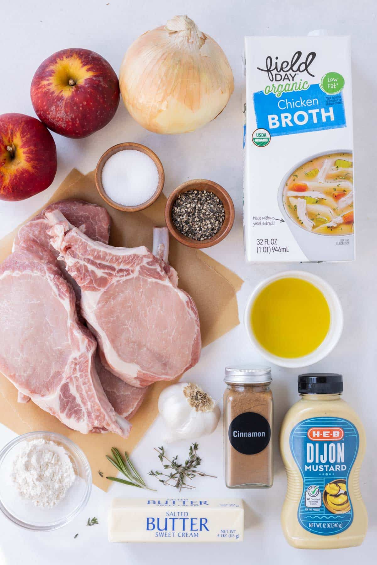 Pork chops, apple, onion, broth, butter, seasonings, and mustard are the main ingredients for this dish.