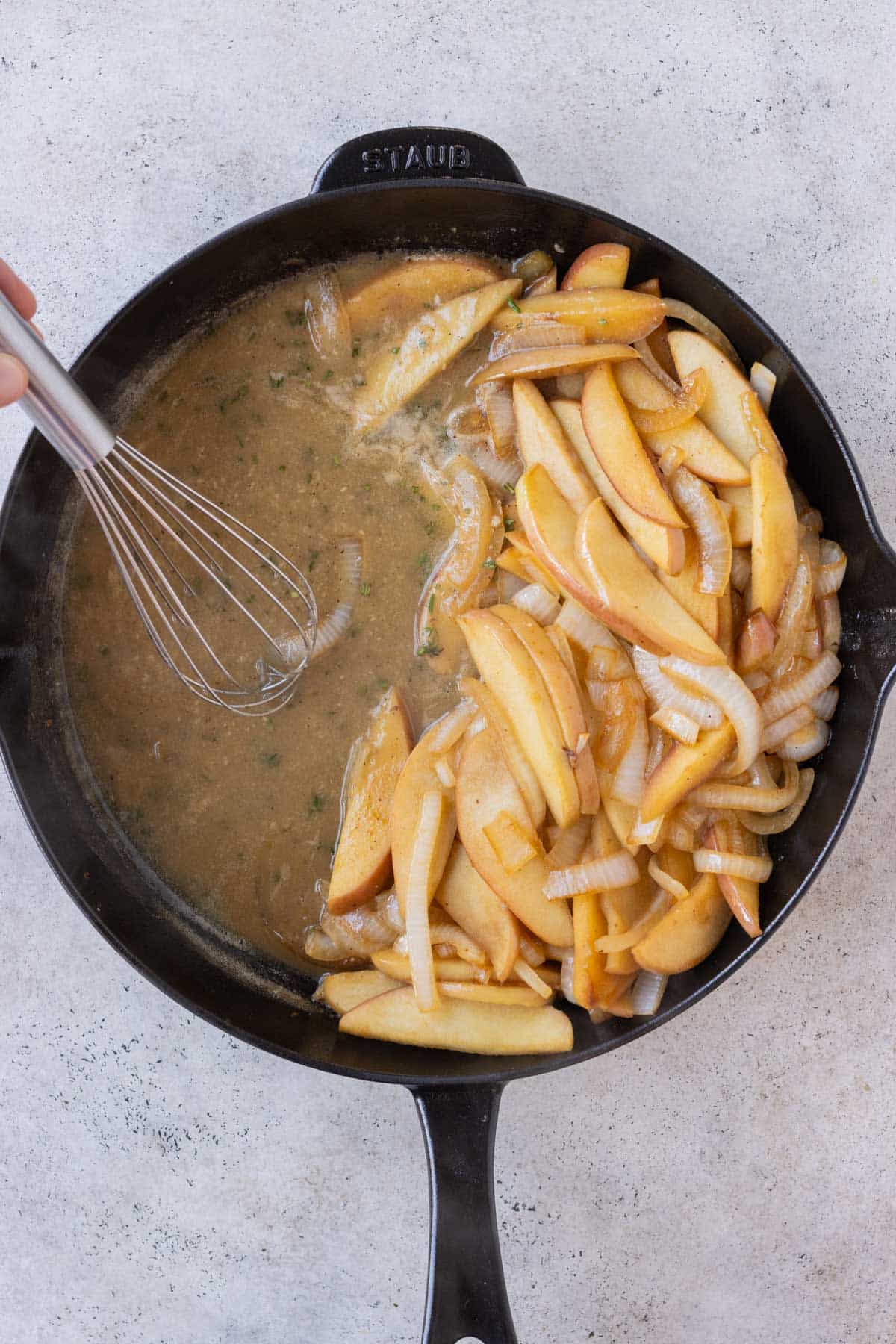 A sauce is made in the skillet with the apples and onions.