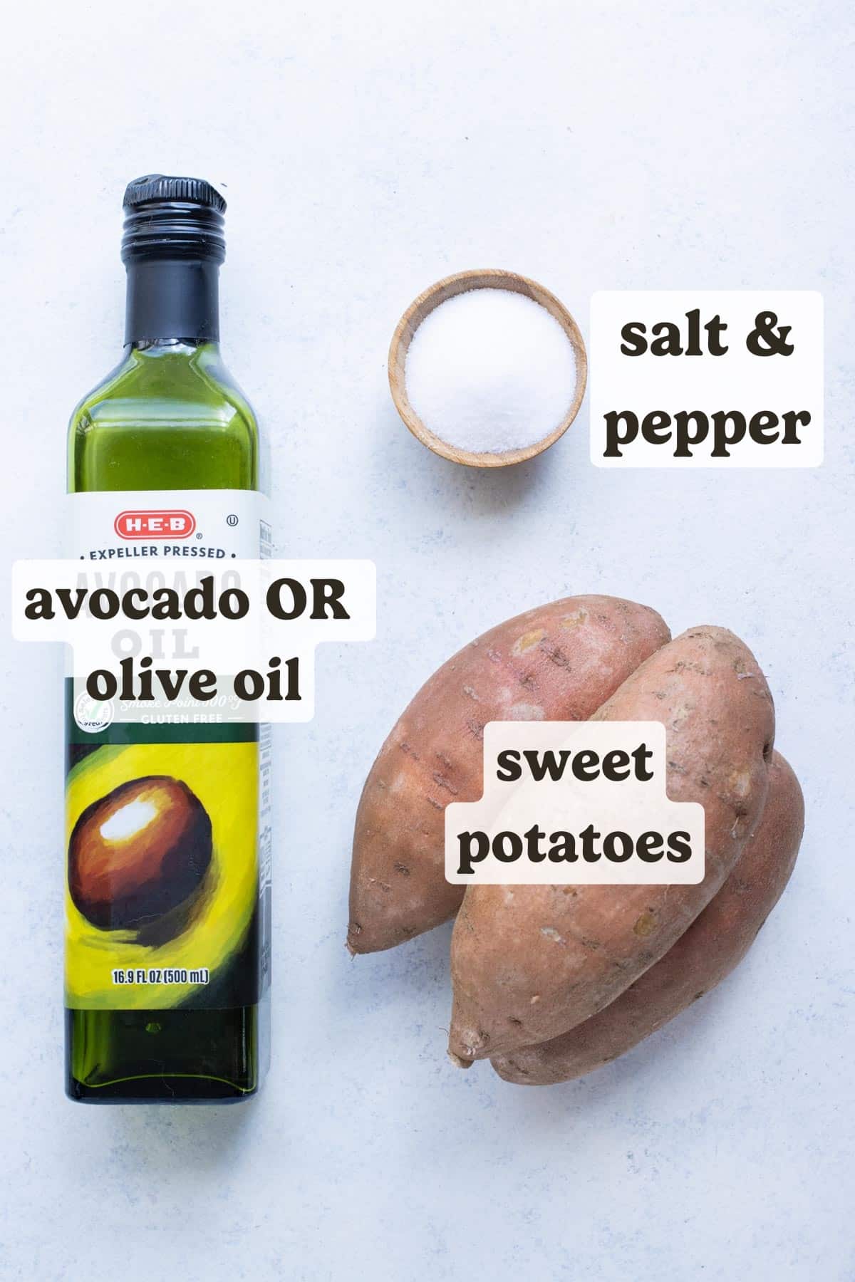 Sweet potatoes, oil, and salt on a table with labels as the ingredients needed to bake sweet potatoes in the oven.