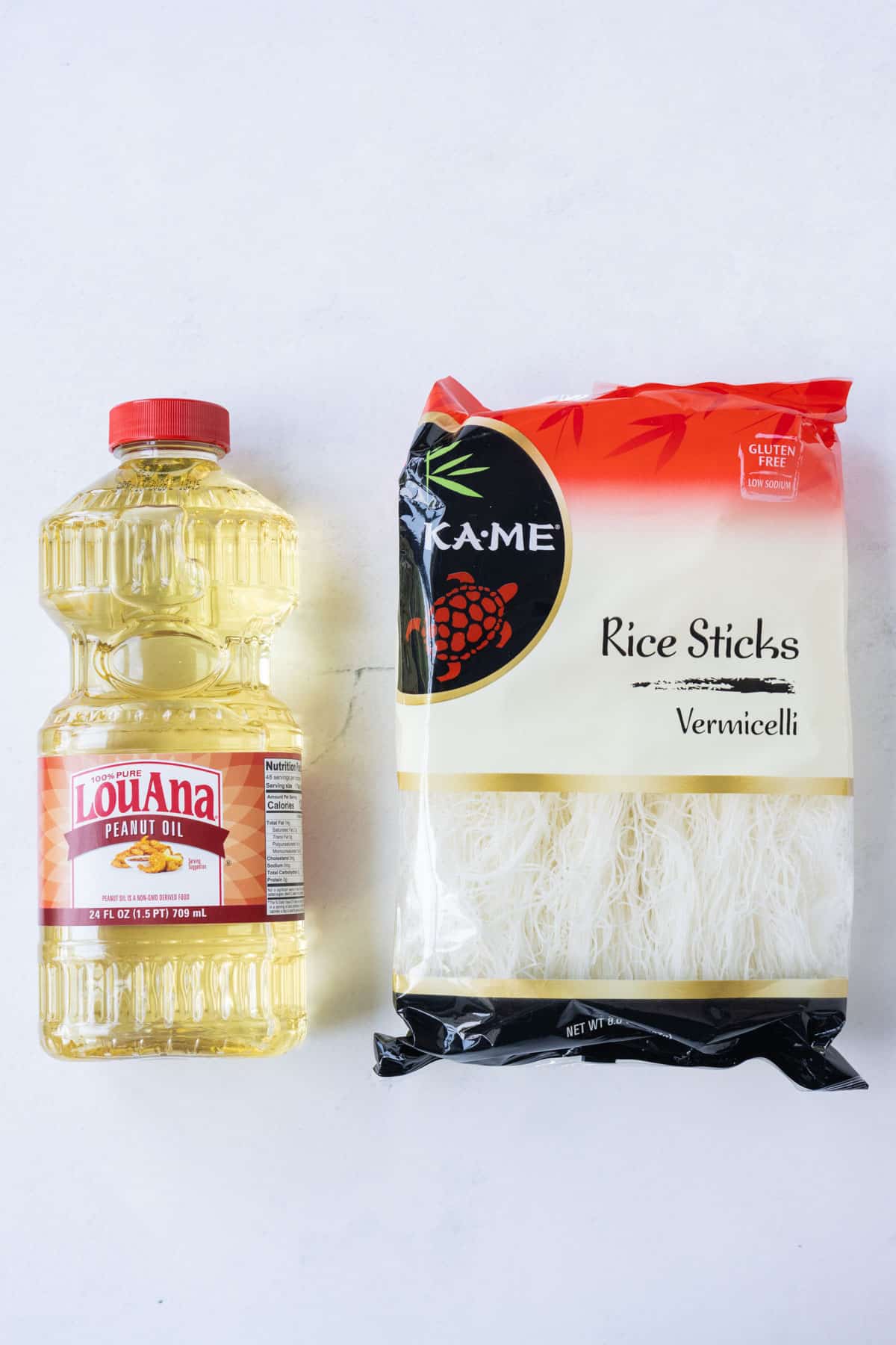 Peanut oil and vermicelli noodles are on a table to make crispy rice noodles.