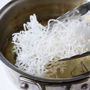 Rice noodles are fried until crispy.