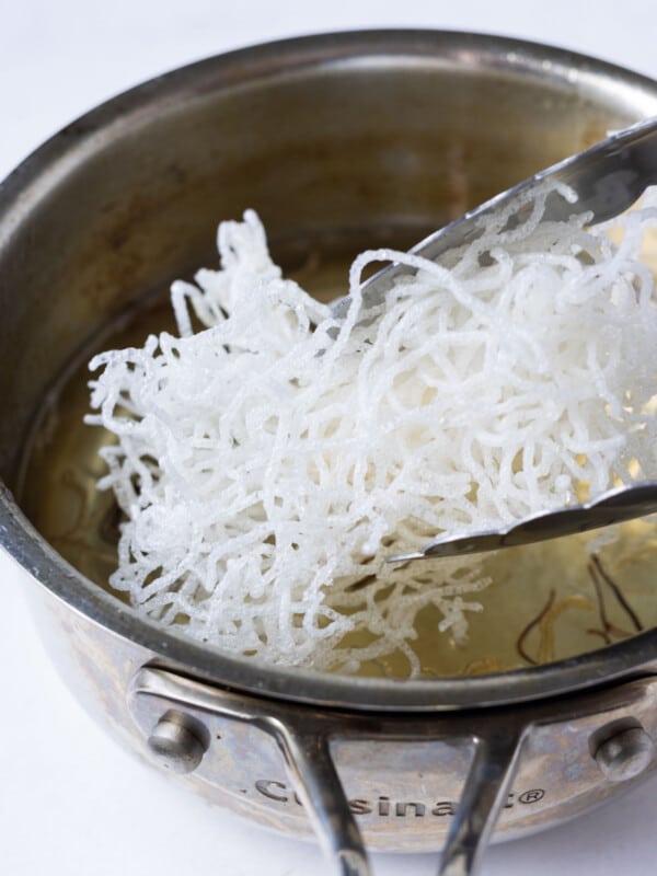 Rice noodles are fried until crispy.