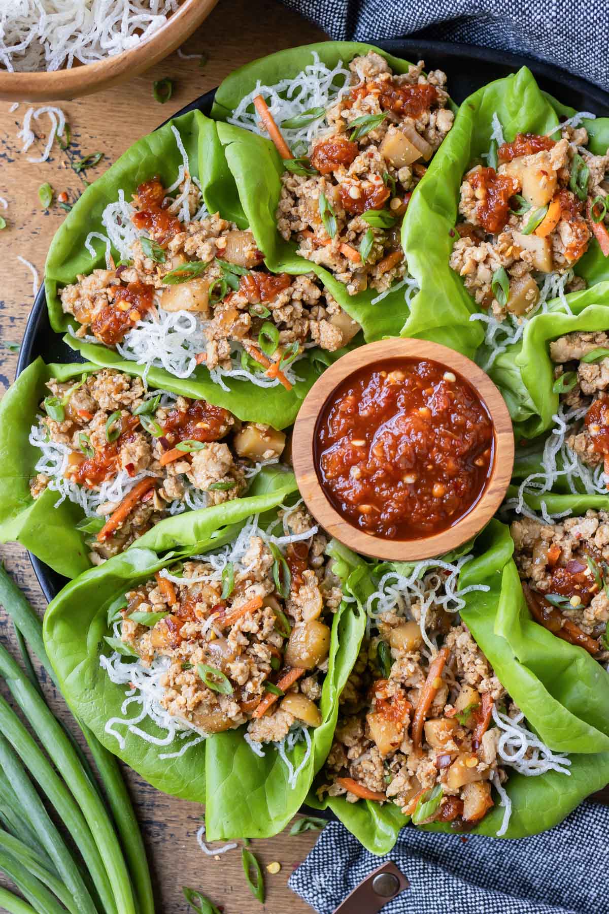 Copycat PF Change's Chicken Lettuce Wraps are plated with a side of Gochujang for a quick weeknight dinner.