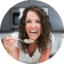 A photo of London Brazil, the author of the food blog Evolving Table, eating a bite of food in her kitchen.