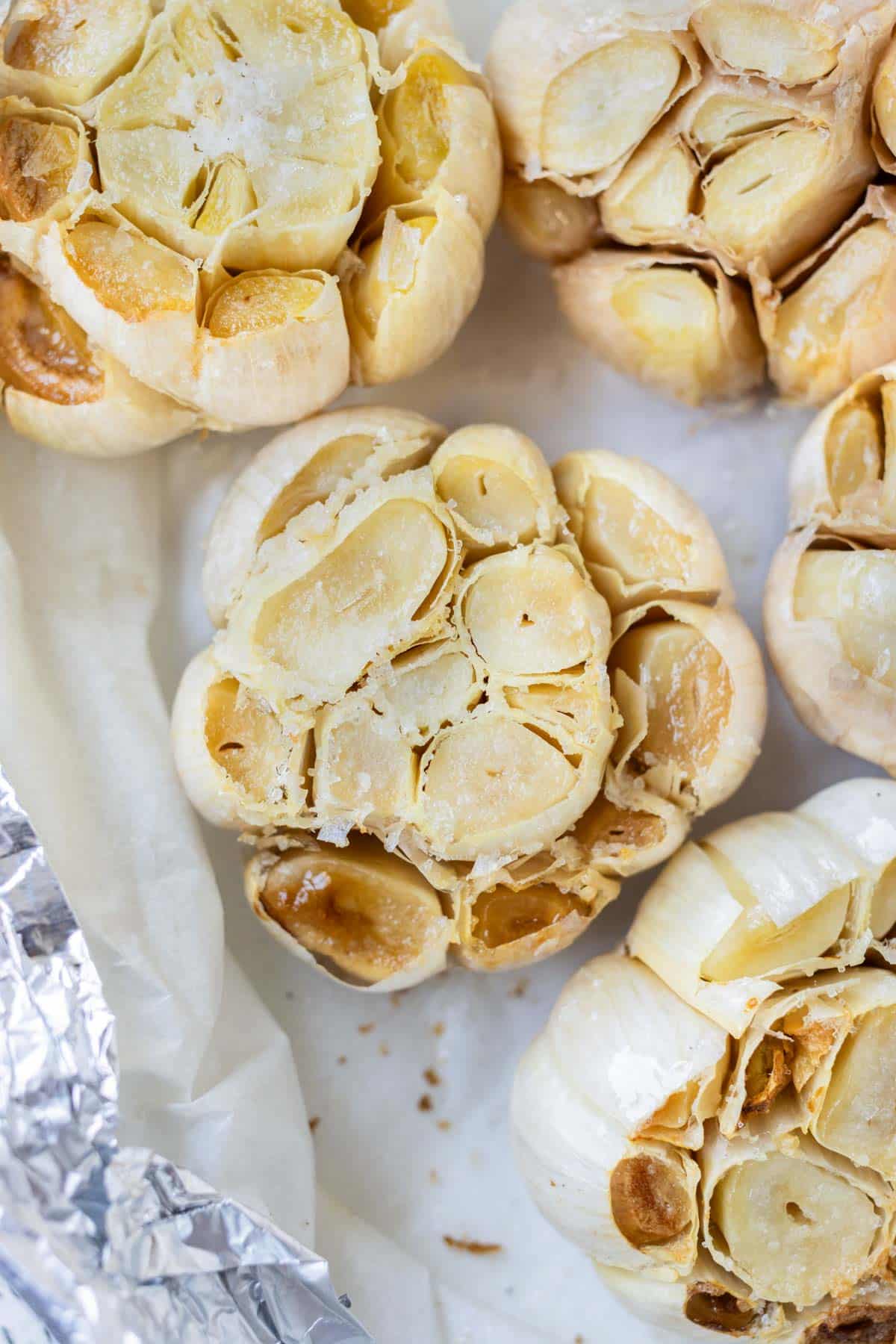 Roasted garlic from the air fryer on parchment paper.