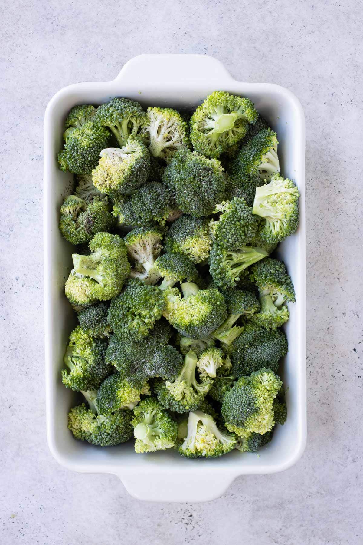 Broccoli is roasted in a casserole dish.