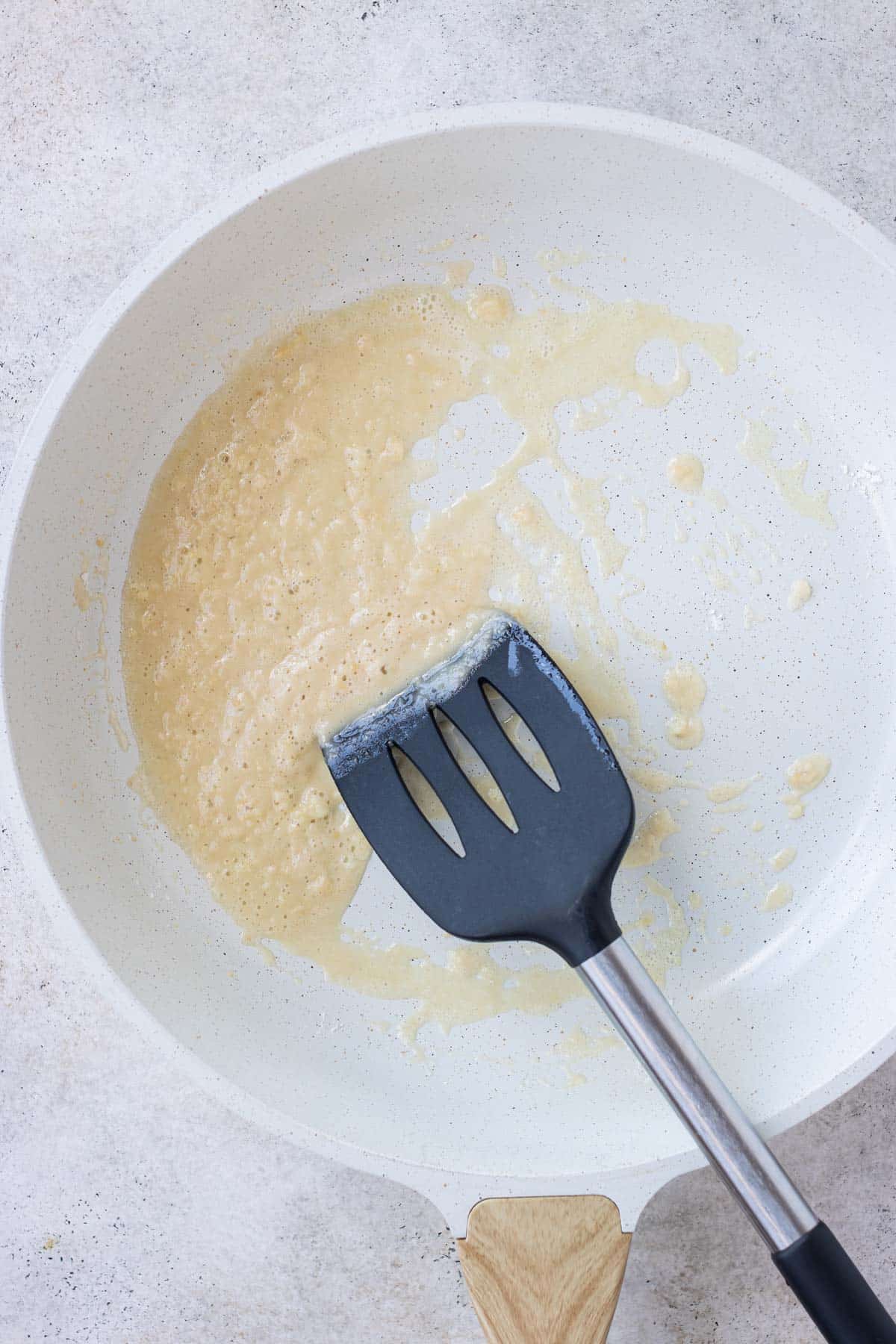 A roux is made in a skillet.