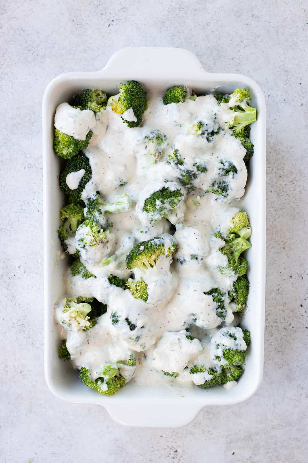 The cheese sauce is poured over the broccoli.