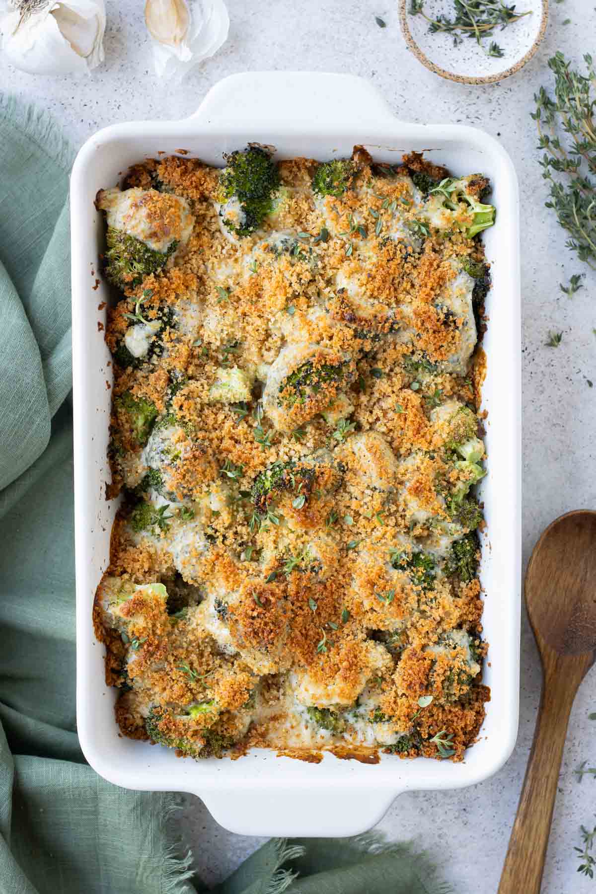 Broccoli au gratin is baked until golden in a white dish.