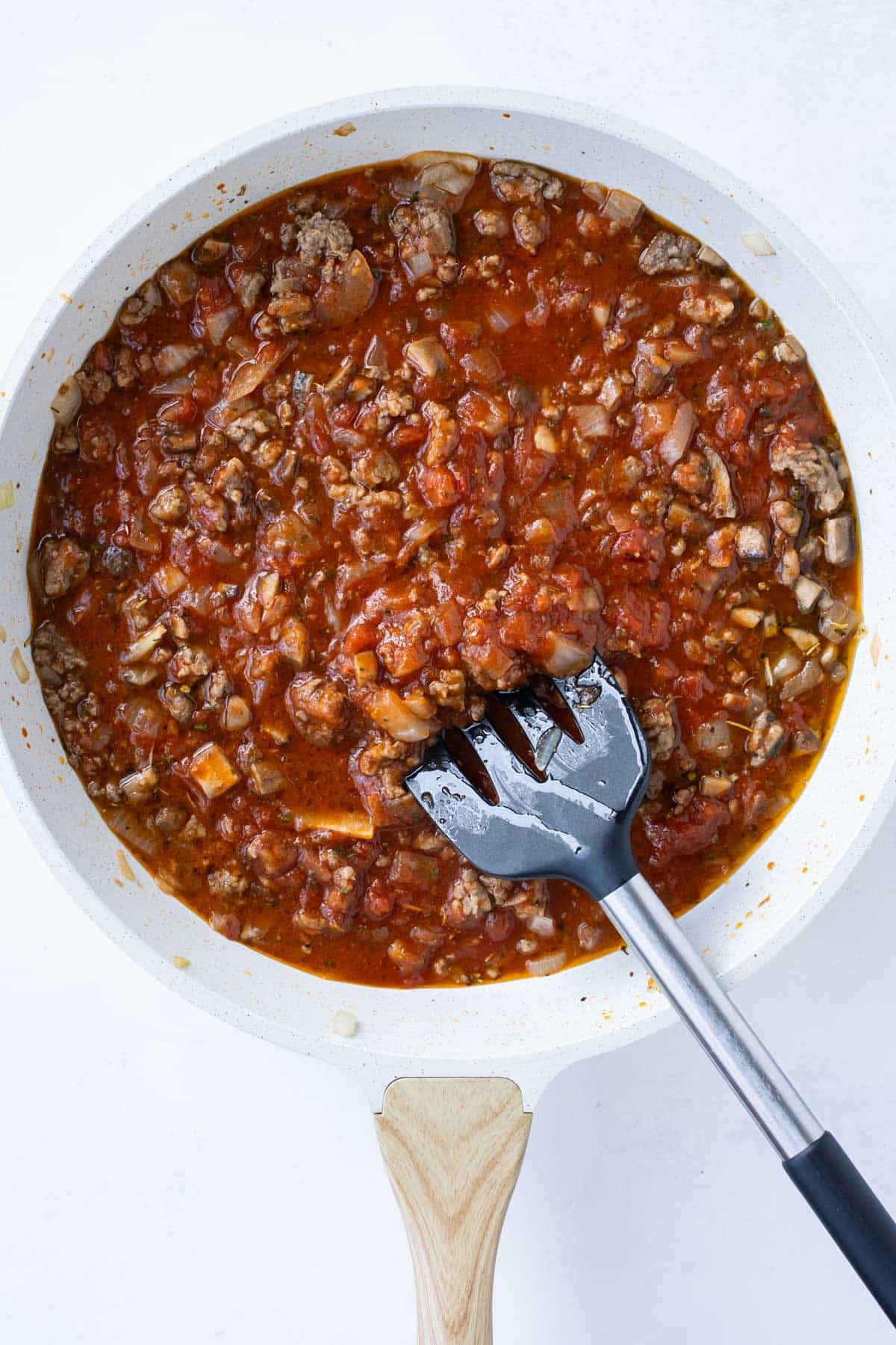 Marinara and seasonings are stirred into the meat and veggies.