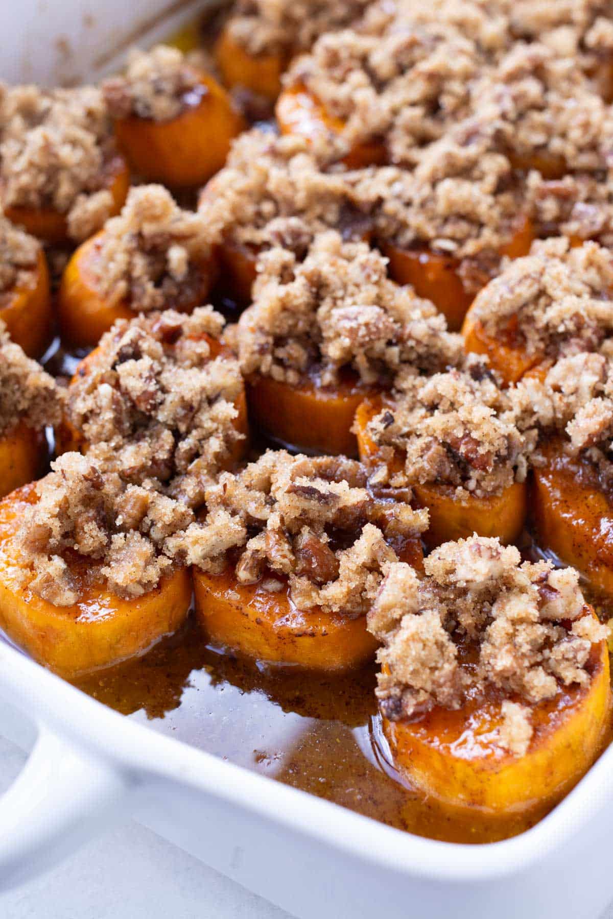 A crumble topping with pecans and brown sugar is added to the sweet potatoes.