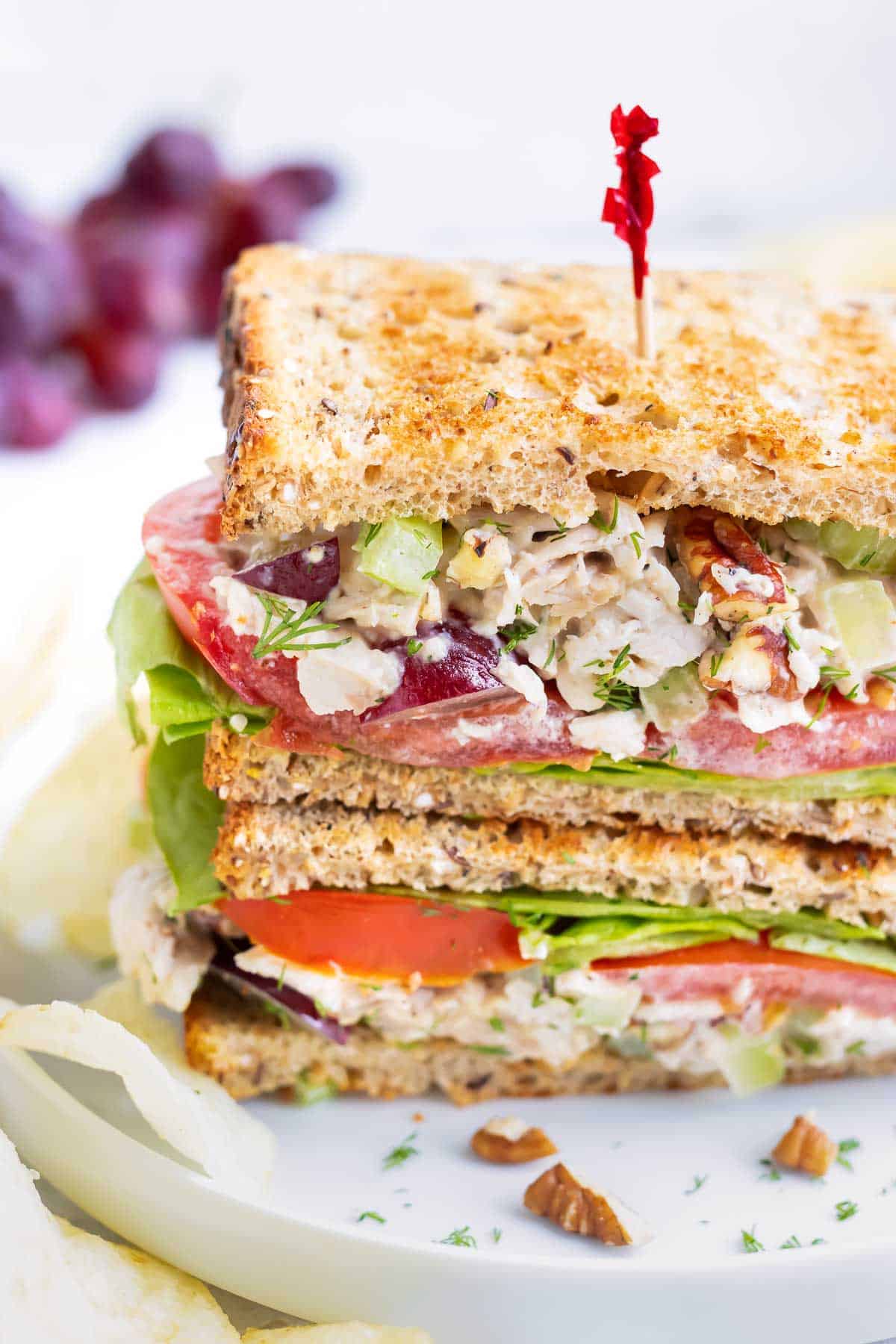 Turkey salad is served on toasted bread with lettuce and tomato.