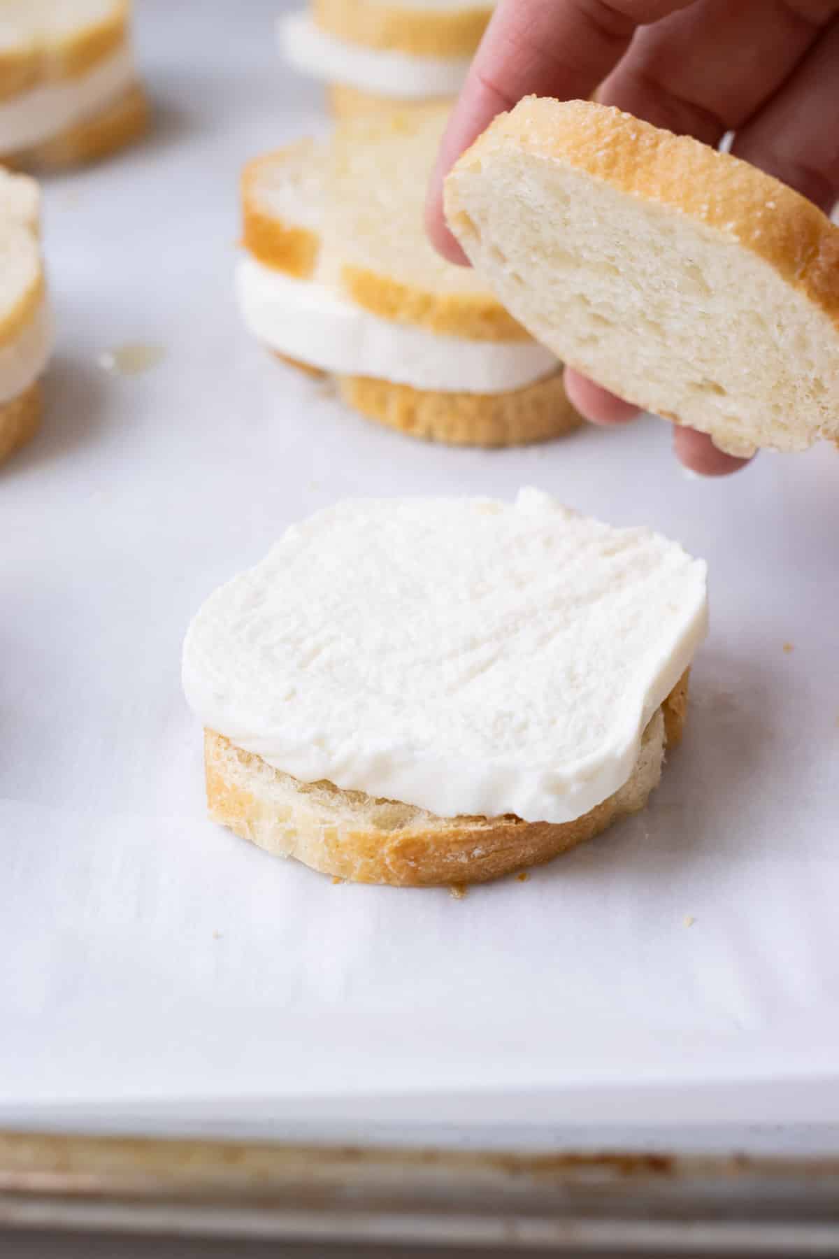 Sliced baguettes are topped with Mozzarella cheese.