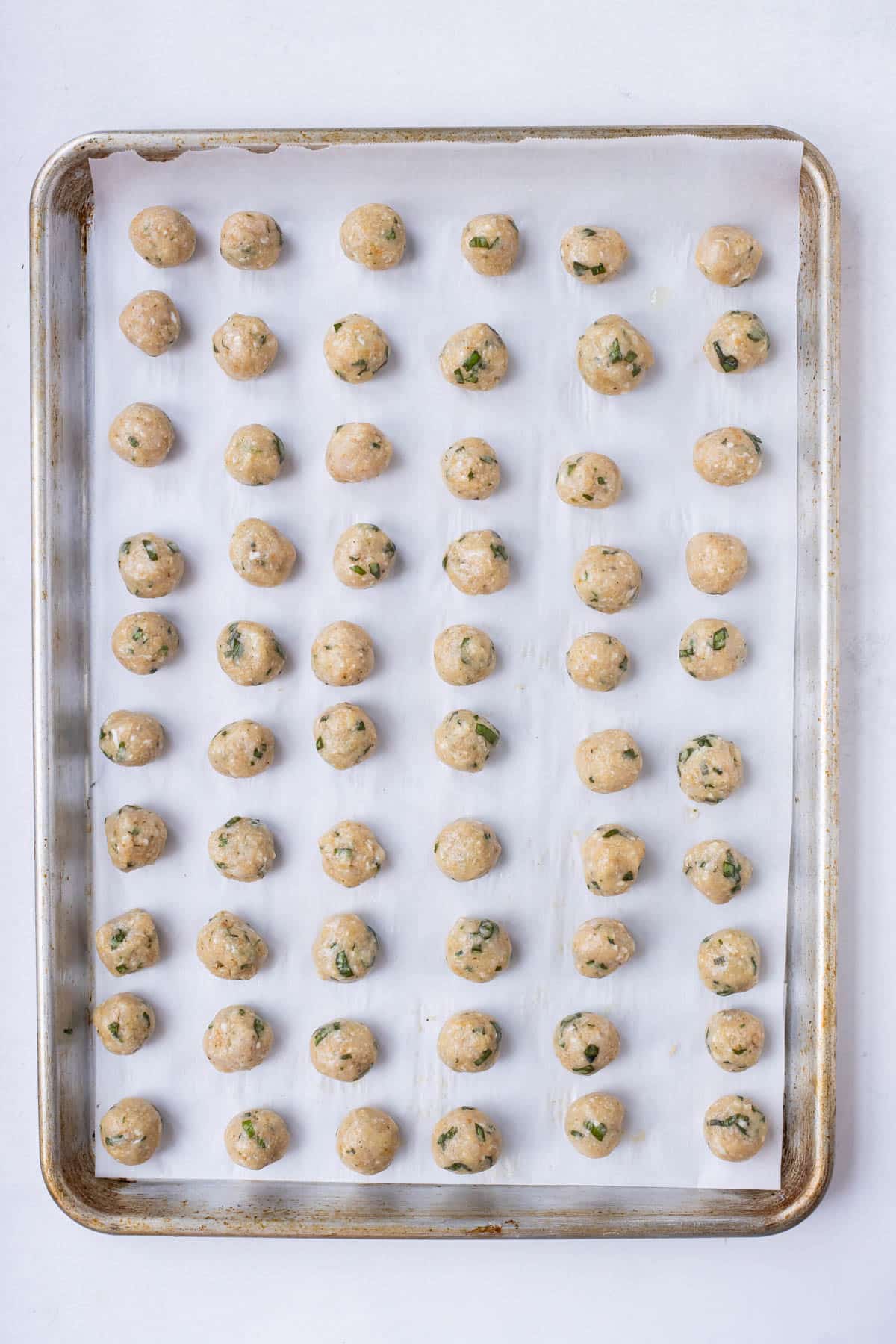 Chicken meatballs are baked in the oven.