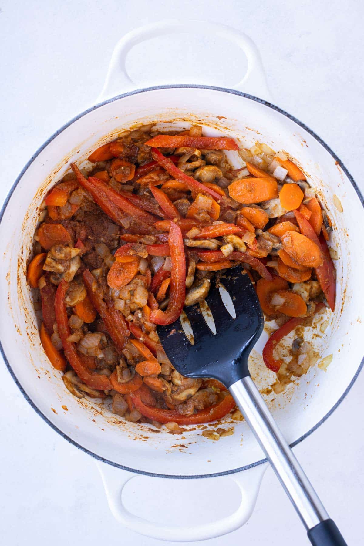 Cooked veggies are seasoned in the pot.