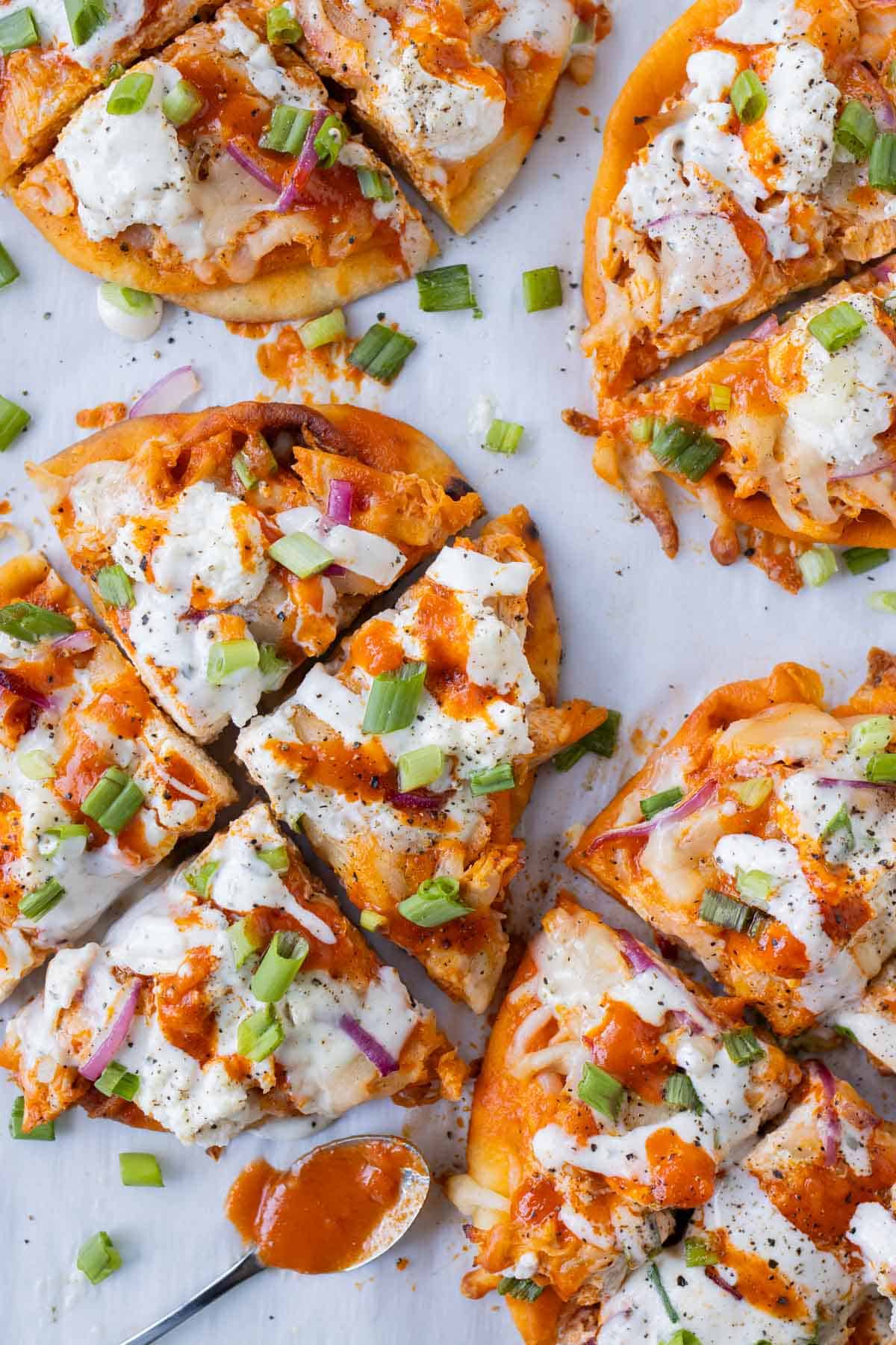 For an easy game day appetizer, bake buffalo chicken naan pizza in the oven.