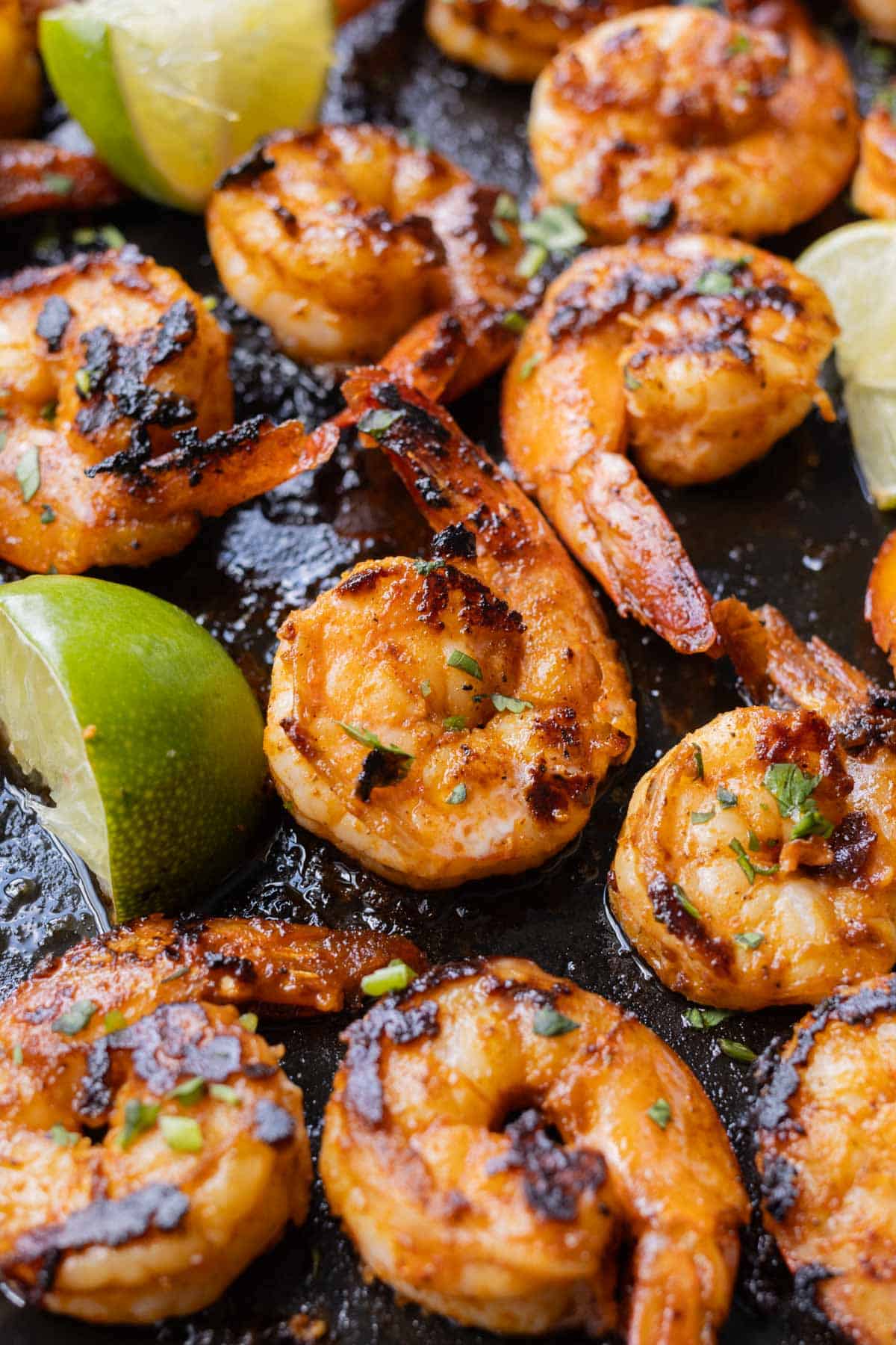 Shrimp is seasoned with a chili garlic lime marinade and cooked in a cast iron skillet.