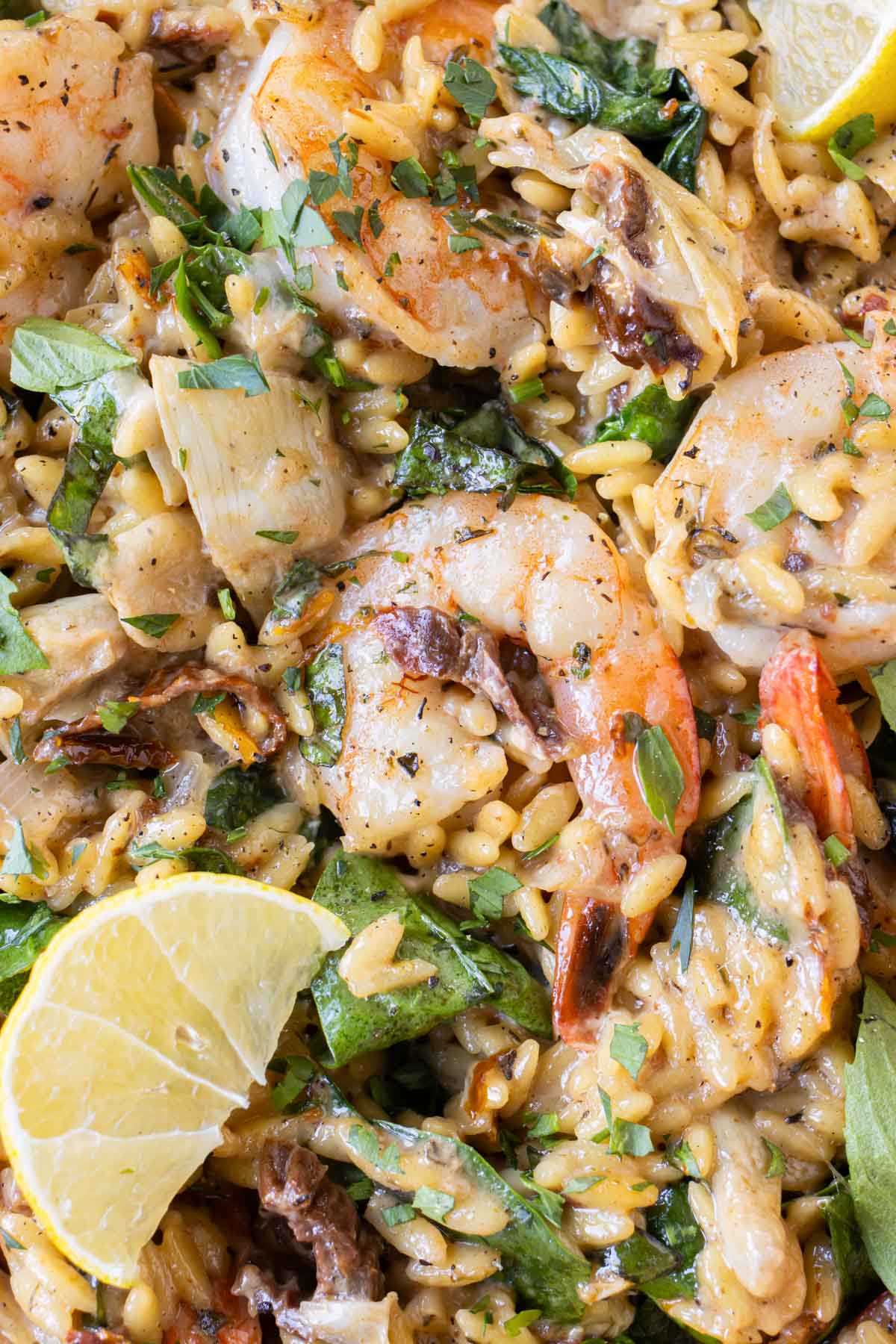 Shrimp orzo pasta is topped with fresh lemon.