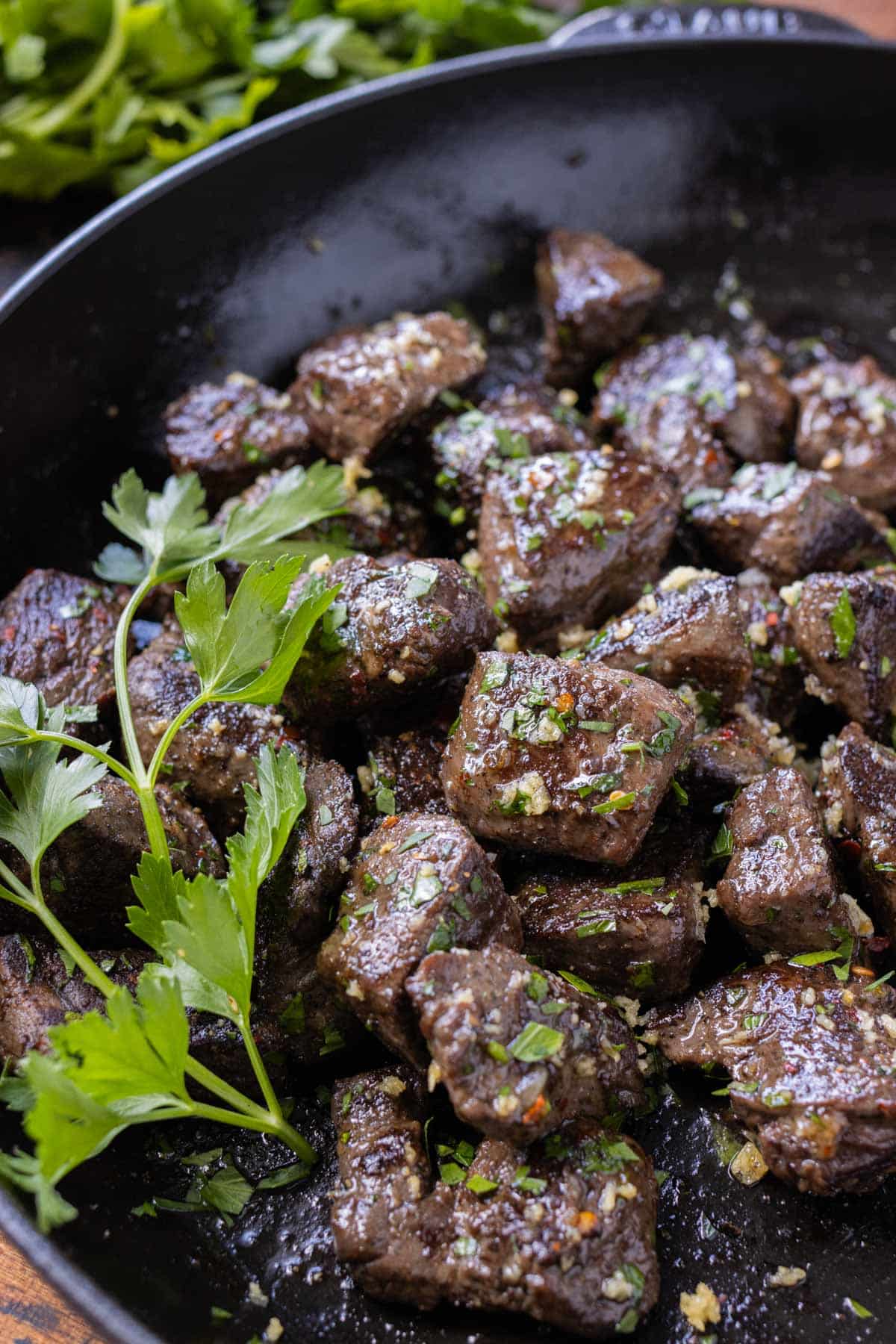 Cook these garlic butter steak bites in a cast iron skillet for a quick meal.