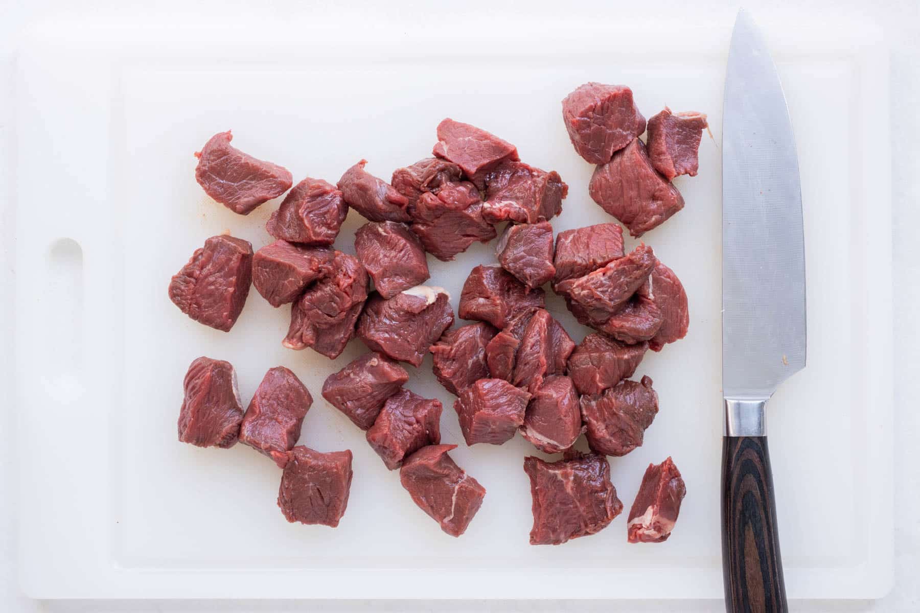 Steak is cut in to cubes.