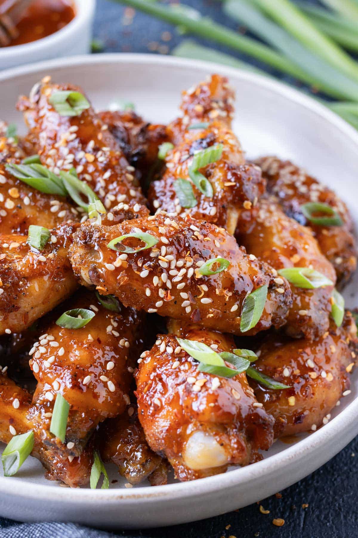 Top these hot honey chicken wings with sliced green onions.