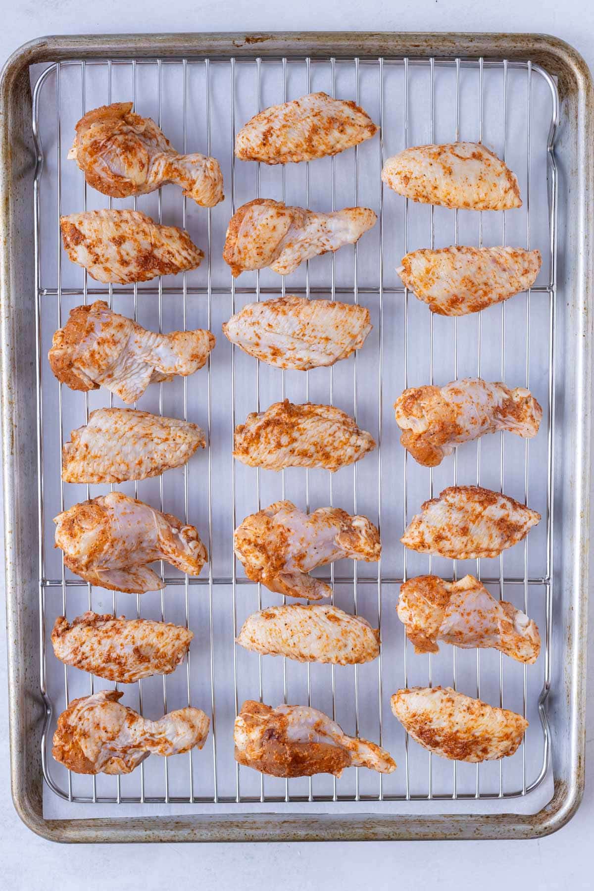 Seasoned wings are baked in the oven.