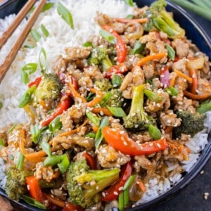 A ground turkey teriyaki rice bowl is served with chopsticks.