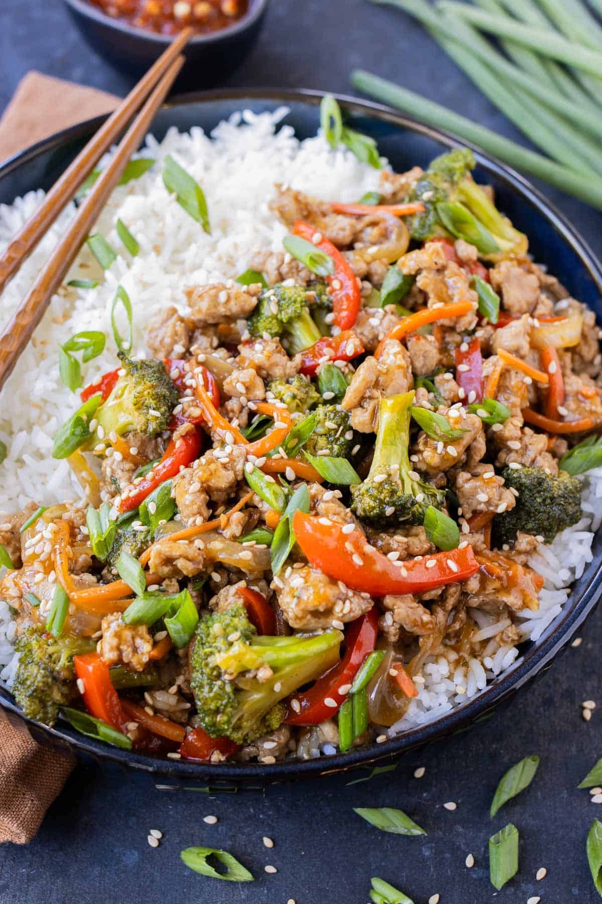 A ground turkey teriyaki rice bowl is served with chopsticks.